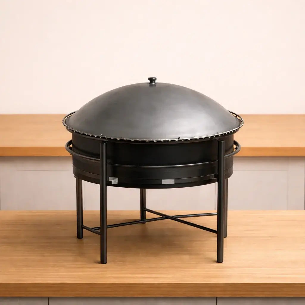 Abou Che3le heavy-duty portable gas saj stove with a convex flatbread cooktop and black metal stand.
