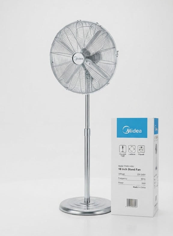 A silver Midea pedestal fan stands next to its white and blue product packaging box on a clean white background.
